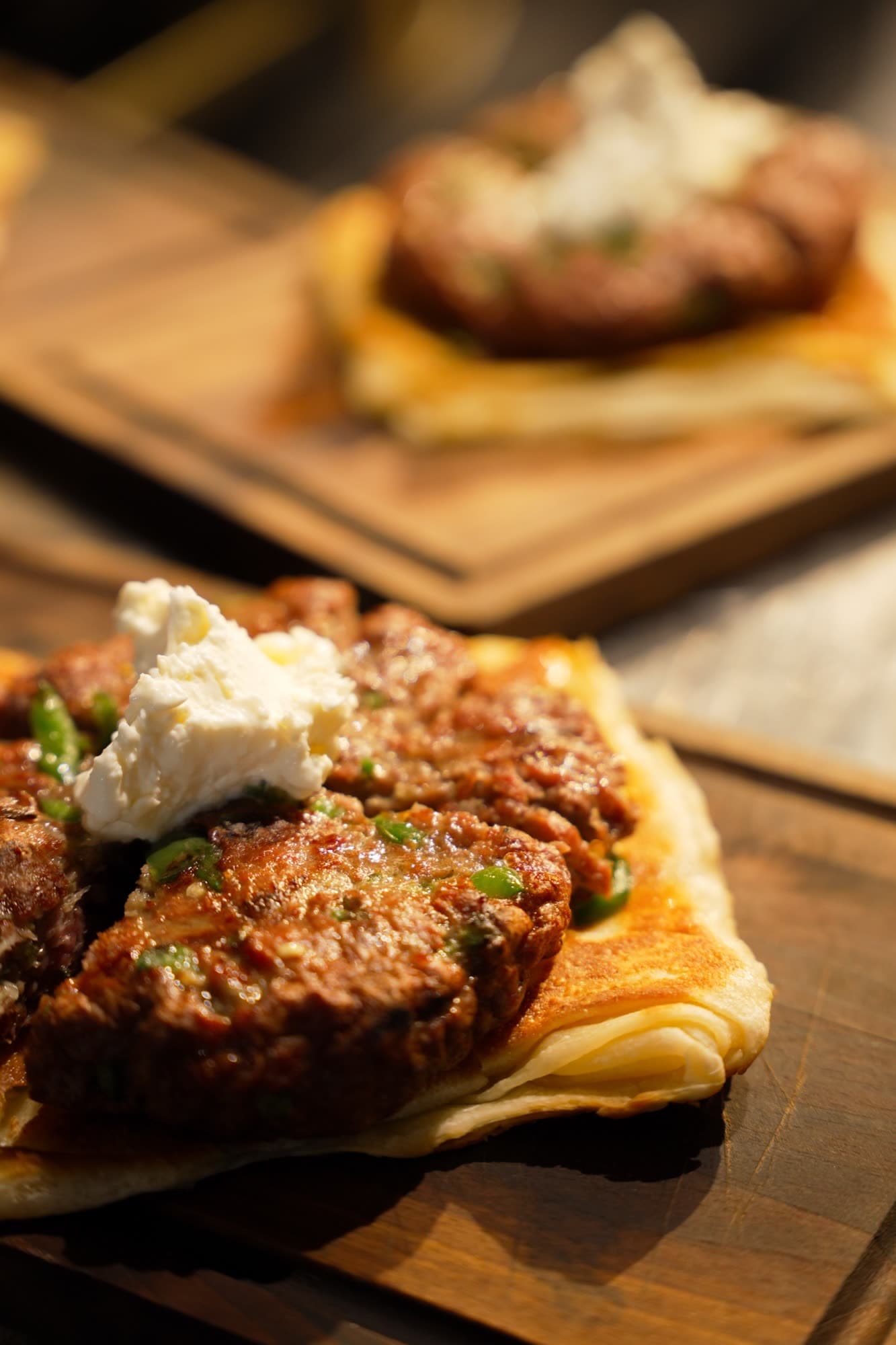 Pljeskavica with kajmak on fresh burek flatbread