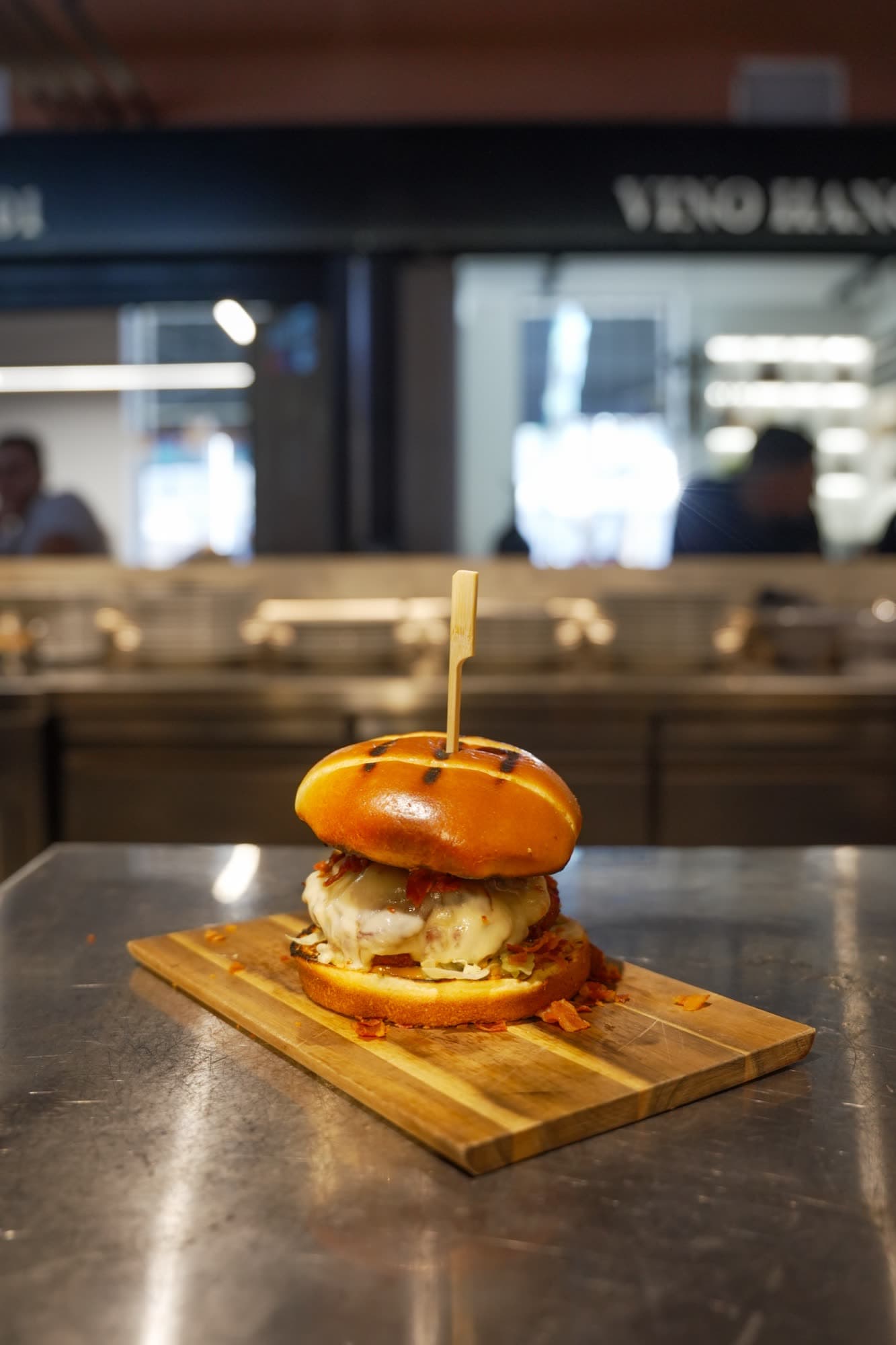 Smash burger on wooden board with Hangar Food Market branding