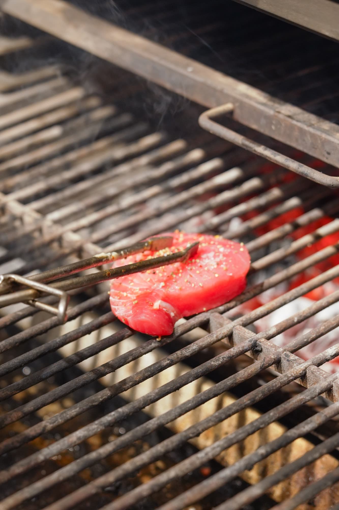 Tuna steak on Josper grill with smoke rising