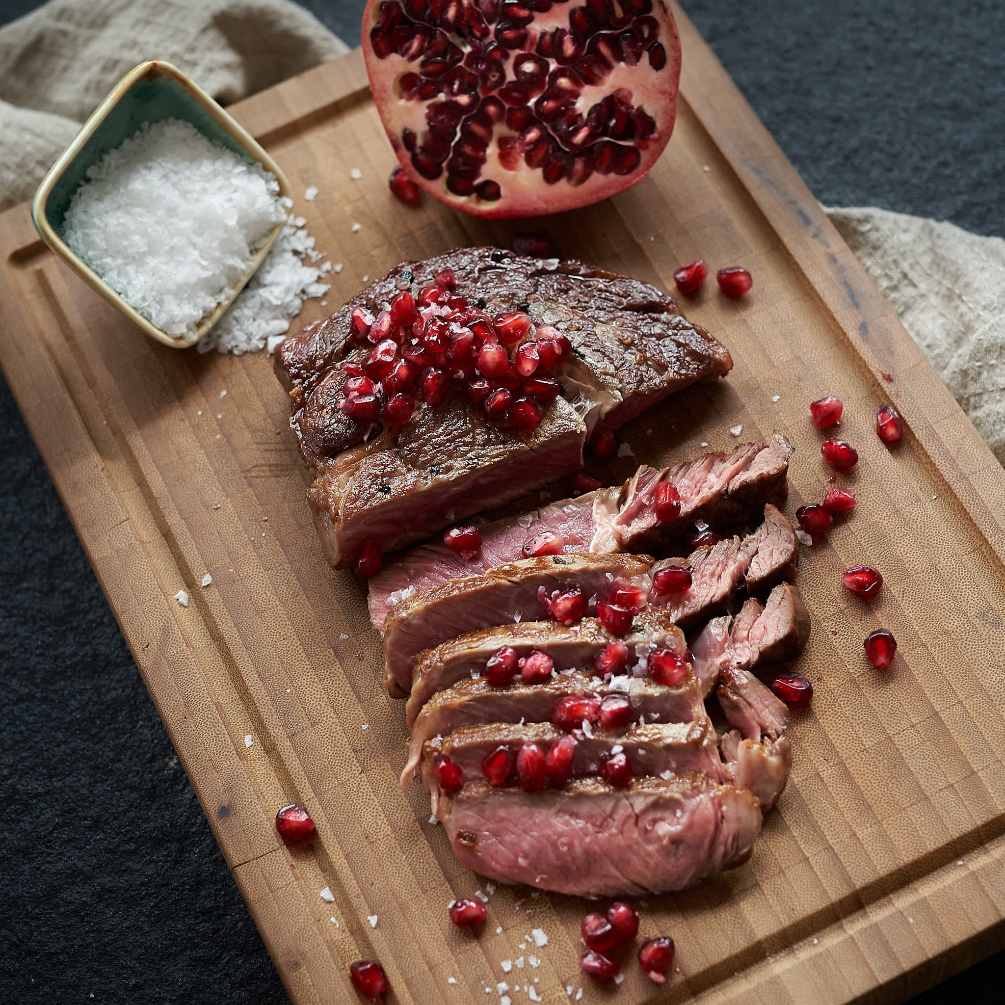 Dry aged rib eye steak close-up showing glazed crust and juicy interior